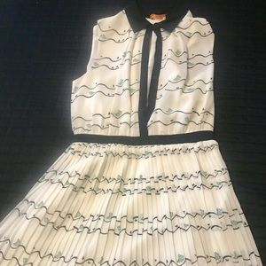 Dress with button up top and pleated skirt.